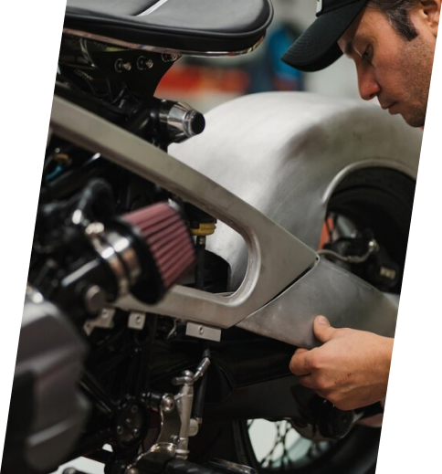 A man working on the engine of a motorcycle.