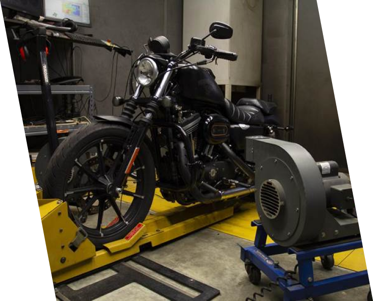 A motorcycle is being worked on in the shop.