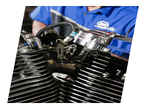 A person working on an engine of a motorcycle.