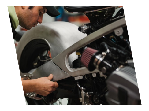 A man working on a motorcycle engine.