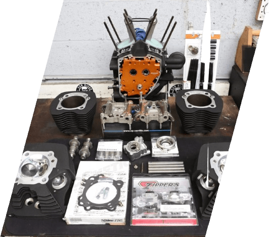 Motorcycle engine parts arranged on a table.